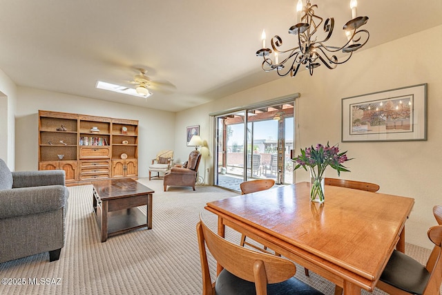 living area with light colored carpet and ceiling fan with notable chandelier