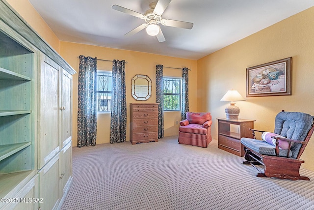 sitting room featuring ceiling fan and carpet