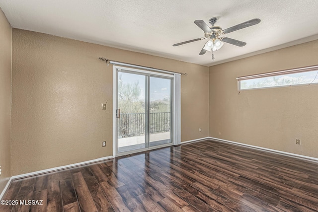spare room with baseboards, a textured wall, ceiling fan, and wood finished floors