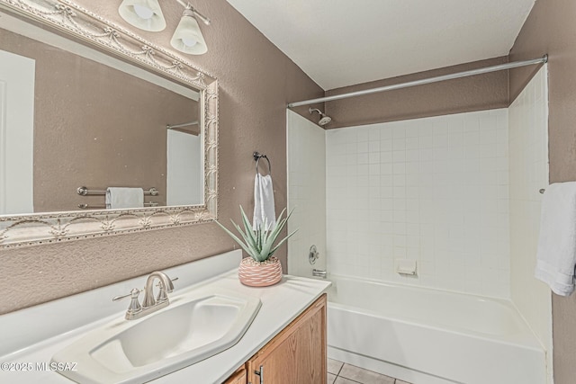 full bath with shower / tub combination, a textured wall, tile patterned floors, and vanity