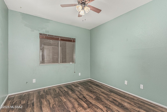 spare room with baseboards, ceiling fan, and wood finished floors