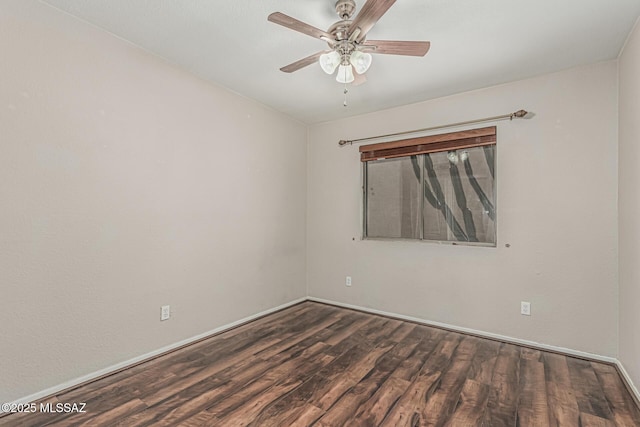 empty room with baseboards, a ceiling fan, and dark wood finished floors