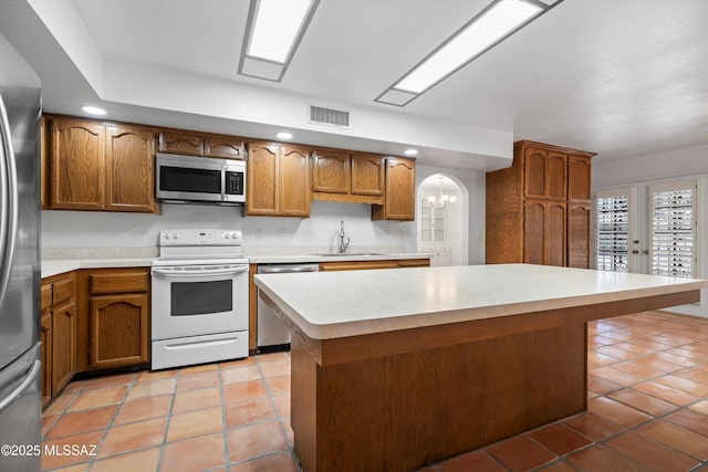 kitchen featuring visible vents, a sink, light countertops, stainless steel appliances, and light tile patterned flooring