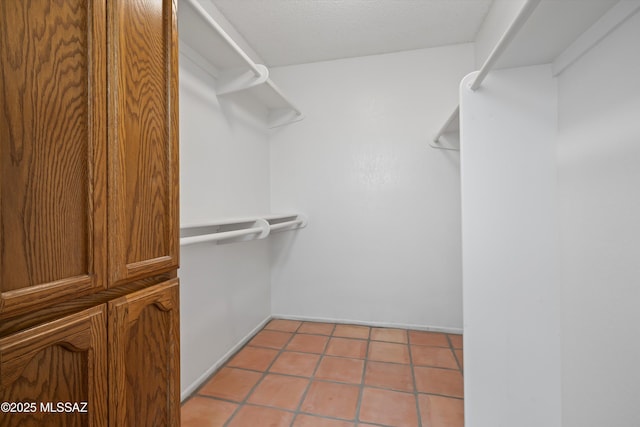 spacious closet with light tile patterned flooring