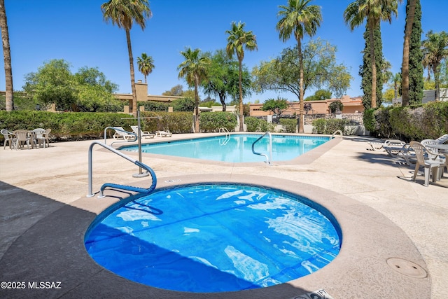 pool featuring a patio and fence