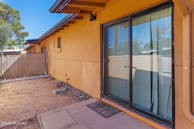 exterior space with fence and stucco siding