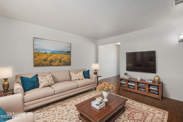 living room with visible vents and wood finished floors