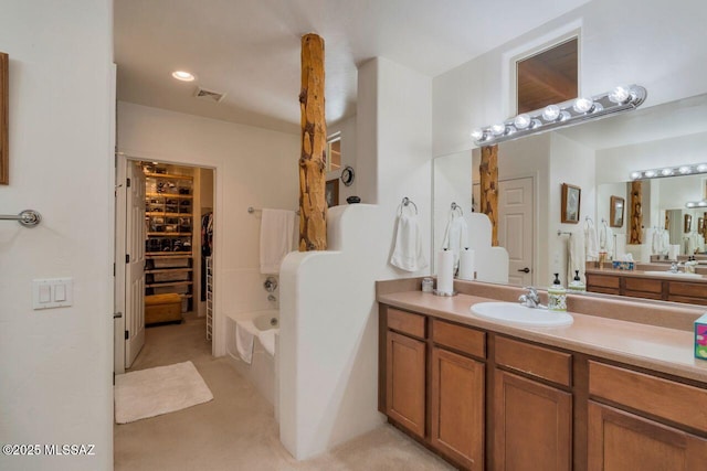 7871 W Tree Frog Trl, Tucson, AZ 85735 - bathroom featuring vanity, a bath, and a spacious closet