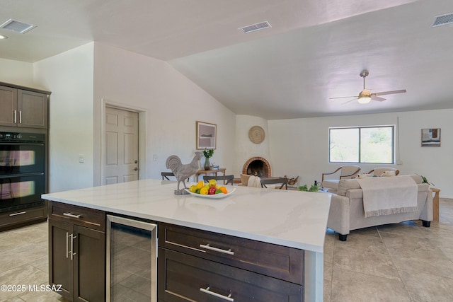 4921 N Boyd Ln, Tucson, AZ 85750 - kitchen with beverage cooler, dobule oven black, and visible vents