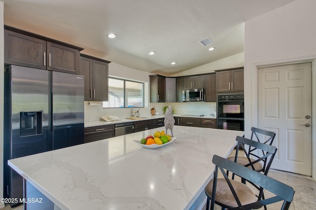 4921 N Boyd Ln, Tucson, AZ 85750 - kitchen featuring dark brown cabinets, appliances with stainless steel finishes, a sink, visible vents, and vaulted ceiling