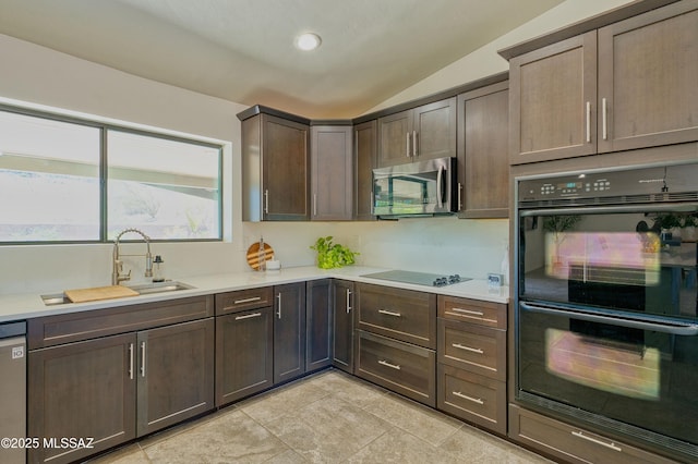 4921 N Boyd Ln, Tucson, AZ 85750 - kitchen with lofted ceiling, dark brown cabinets, light countertops, a sink, and black appliances