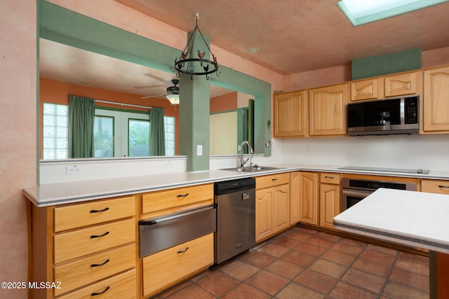 kitchen featuring a sink, light brown cabinets, light countertops, stainless steel appliances, and a warming drawer