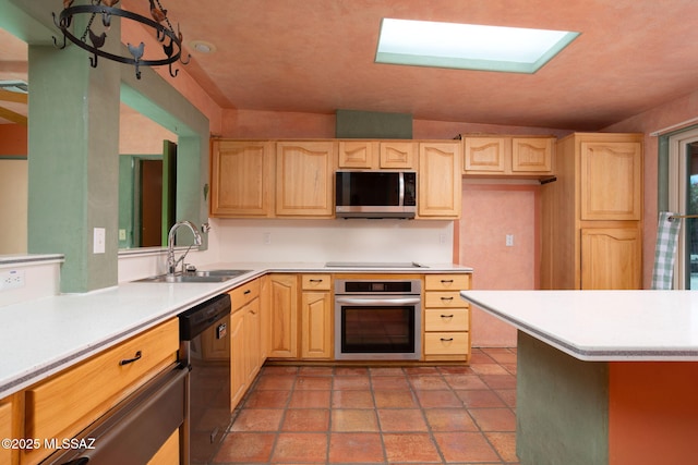 kitchen featuring a sink, light brown cabinets, stainless steel appliances, and light countertops