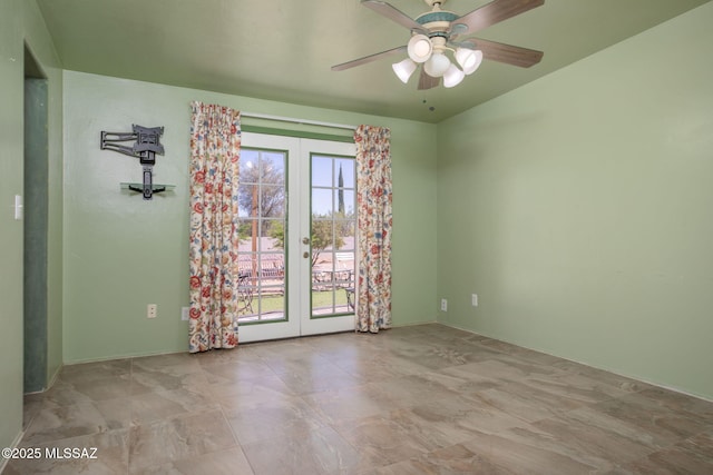 empty room with a ceiling fan and french doors