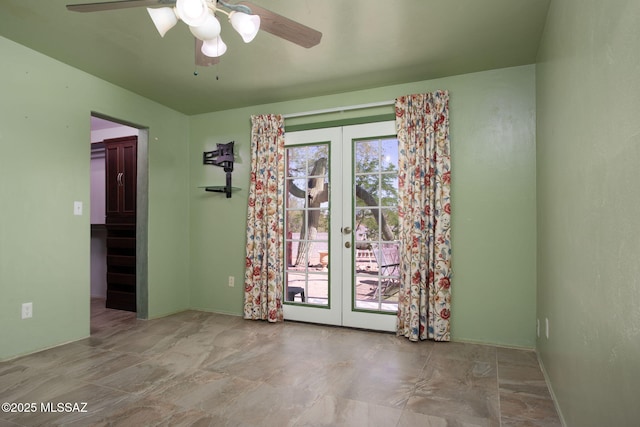 unfurnished dining area with a ceiling fan and french doors