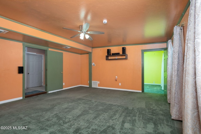 carpeted empty room with a ceiling fan, baseboards, and visible vents