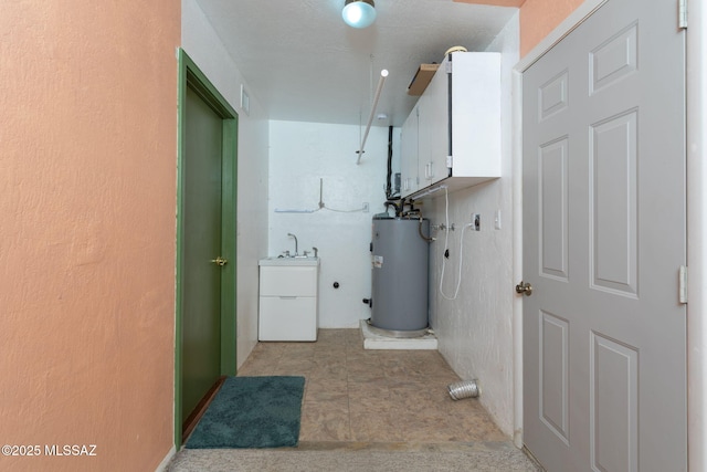 laundry area featuring cabinet space and water heater