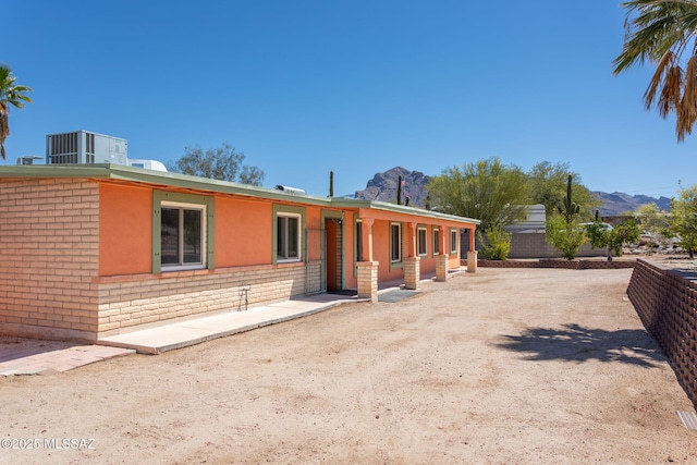 exterior space featuring brick siding and a mountain view