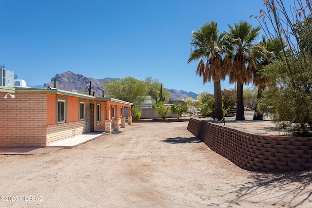 exterior space featuring fence and a mountain view