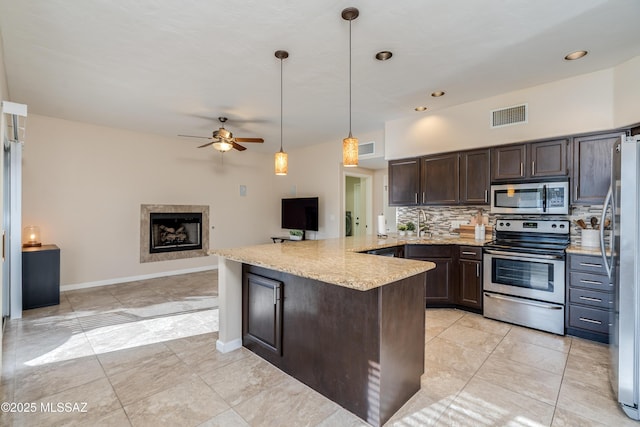 10261 N Wild Turkey Ln, Oro Valley, AZ 85737 - kitchen featuring visible vents, a peninsula, dark brown cabinets, ceiling fan, and stainless steel appliances