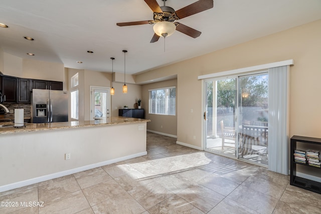 10261 N Wild Turkey Ln, Oro Valley, AZ 85737 - kitchen featuring light stone counters, stainless steel fridge, a ceiling fan, decorative light fixtures, and recessed lighting