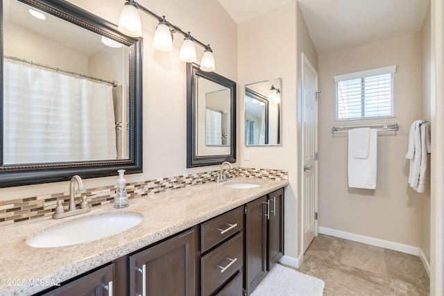 10261 N Wild Turkey Ln, Oro Valley, AZ 85737 - full bathroom featuring a sink, baseboards, and double vanity
