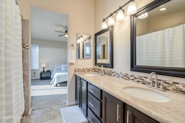 10261 N Wild Turkey Ln, Oro Valley, AZ 85737 - ensuite bathroom featuring double vanity, ceiling fan, a sink, and ensuite bath