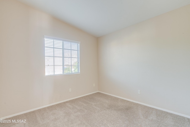 10261 N Wild Turkey Ln, Oro Valley, AZ 85737 - carpeted empty room featuring baseboards and lofted ceiling