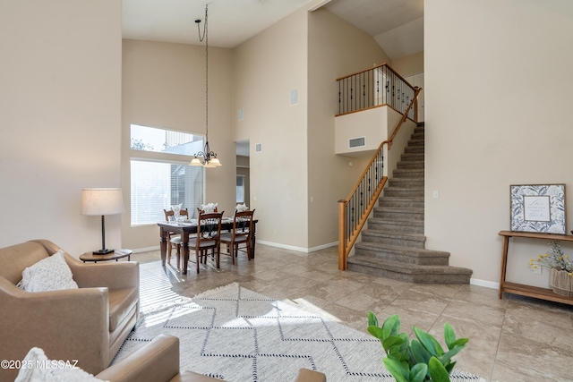 10261 N Wild Turkey Ln, Oro Valley, AZ 85737 - living area featuring baseboards, an inviting chandelier, stairway, and high vaulted ceiling