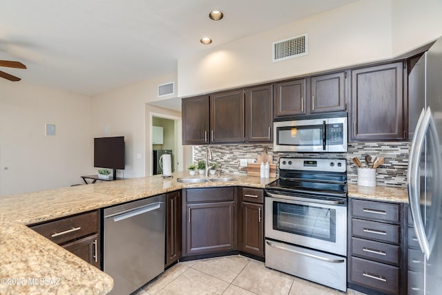 10261 N Wild Turkey Ln, Oro Valley, AZ 85737 - kitchen featuring visible vents, a sink, appliances with stainless steel finishes, and tasteful backsplash