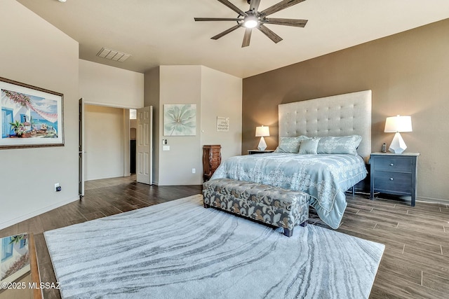 bedroom featuring visible vents, baseboards, ceiling fan, and wood finished floors