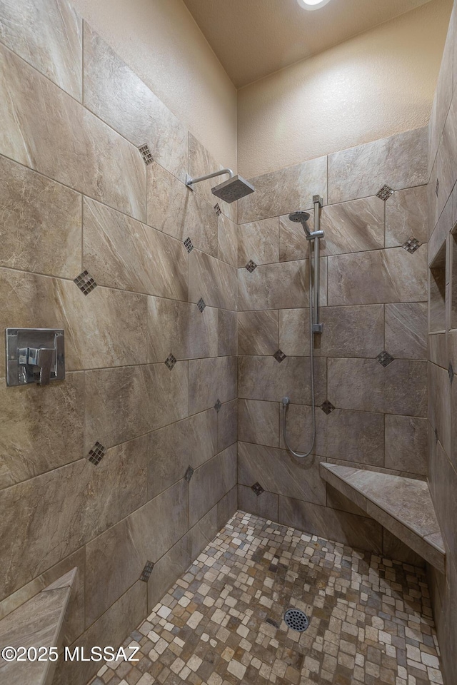 bathroom with tiled shower
