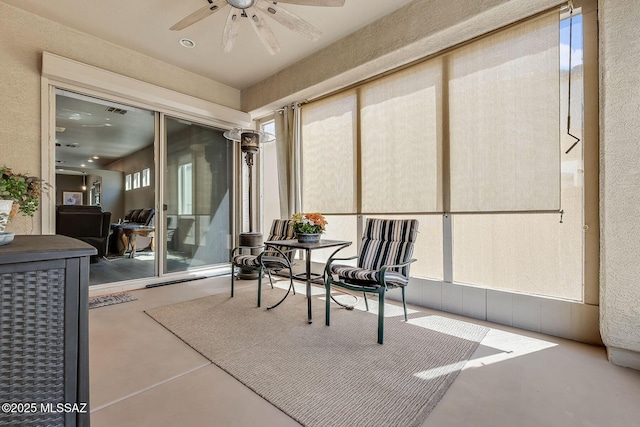 sunroom / solarium featuring a ceiling fan and visible vents