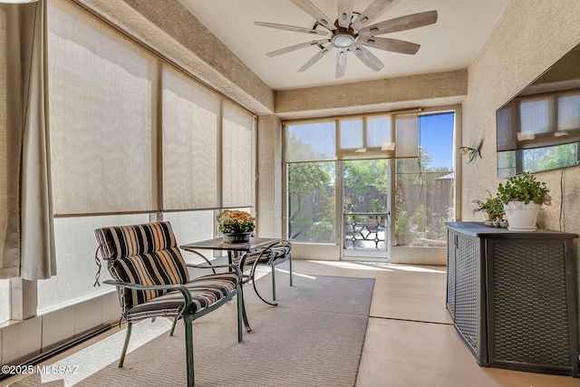 sunroom featuring a ceiling fan and a healthy amount of sunlight