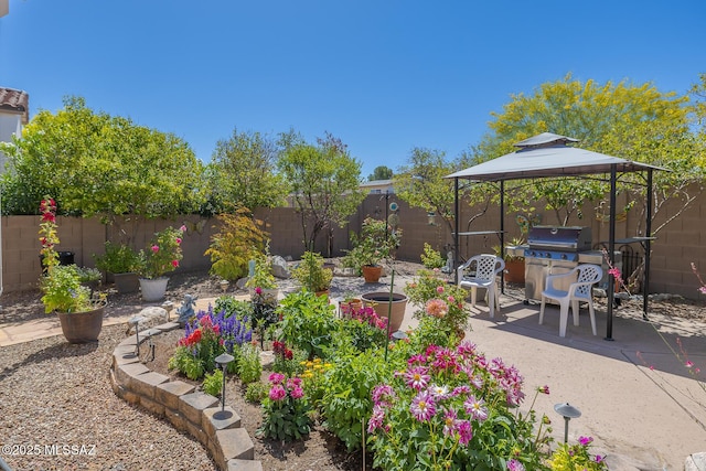 view of yard featuring a patio, a fenced backyard, and a gazebo