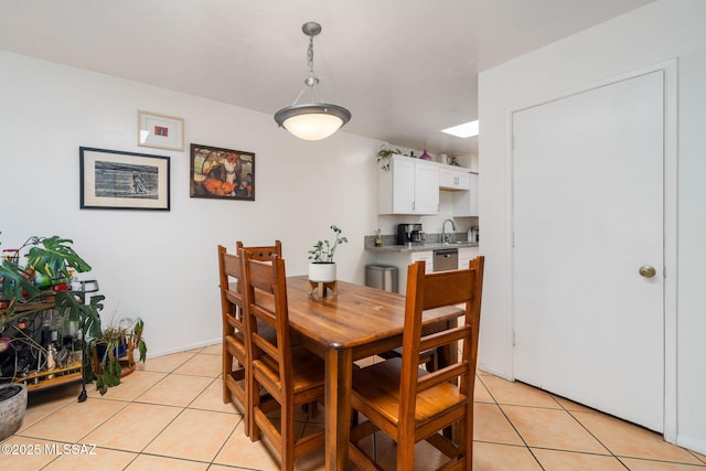 dining room with light tile patterned floors and a skylight