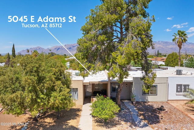 view of front of home with a mountain view and stucco siding