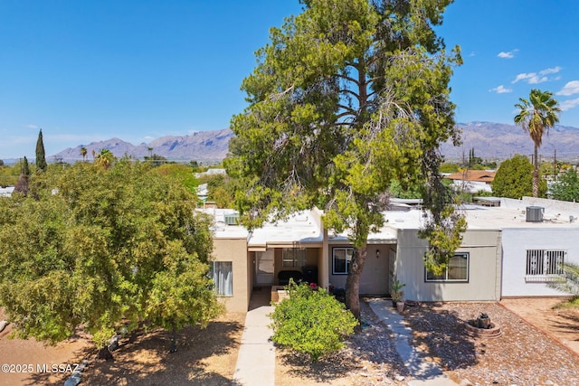 view of front of house featuring stucco siding and a mountain view