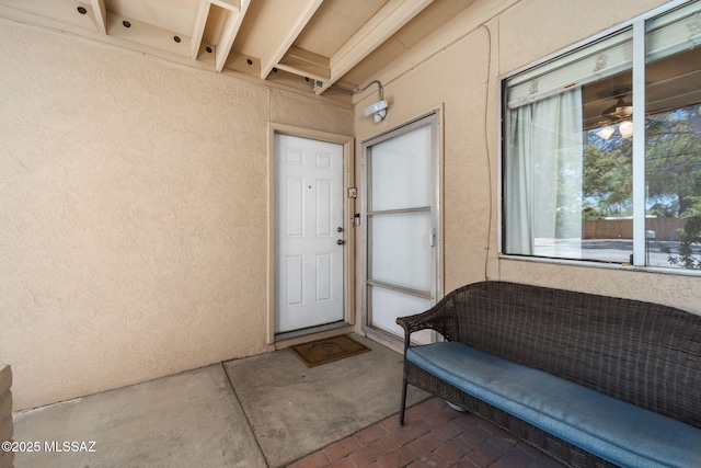 property entrance with stucco siding