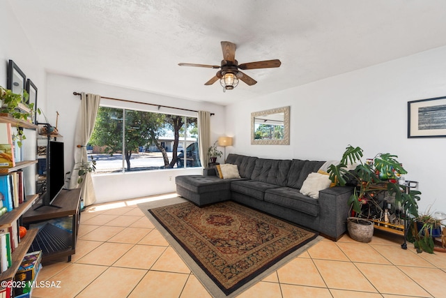 living area featuring ceiling fan and light tile patterned floors