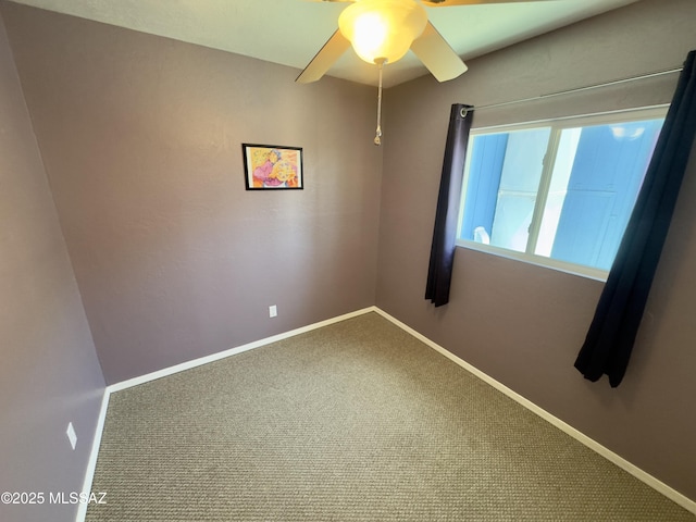 spare room with ceiling fan, carpet floors, and baseboards