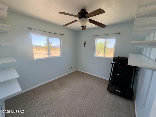 unfurnished bedroom with a ceiling fan, carpet flooring, and baseboards