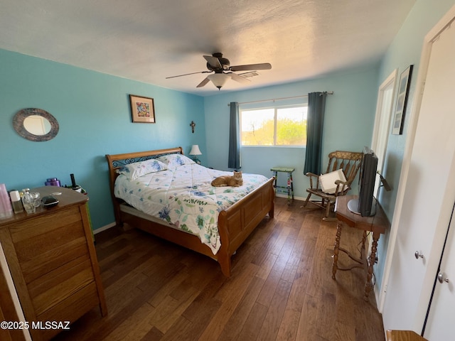 bedroom featuring dark wood finished floors, baseboards, and ceiling fan