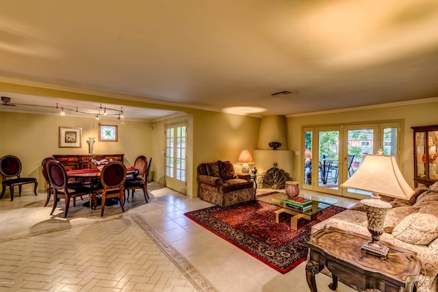 living area featuring french doors, rail lighting, crown molding, and visible vents