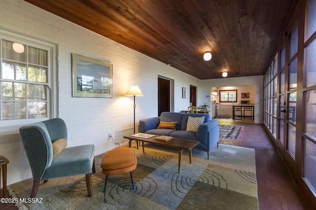 2626 E 4th St, Tucson, AZ 85716 - living area featuring wood ceiling, brick floor, and brick wall