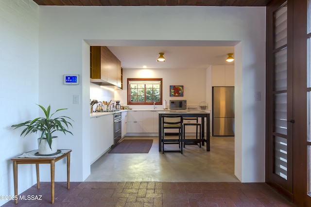2626 E 4th St, Tucson, AZ 85716 - kitchen featuring light countertops, white cabinets, appliances with stainless steel finishes, and modern cabinets