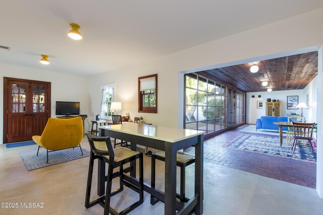2626 E 4th St, Tucson, AZ 85716 - dining room featuring wooden ceiling, brick floor, and visible vents