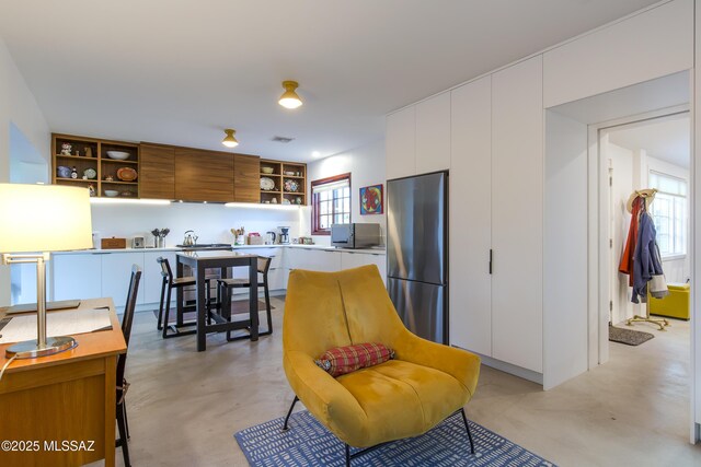 2626 E 4th St, Tucson, AZ 85716 - interior space with finished concrete floors, appliances with stainless steel finishes, modern cabinets, open shelves, and white cabinets