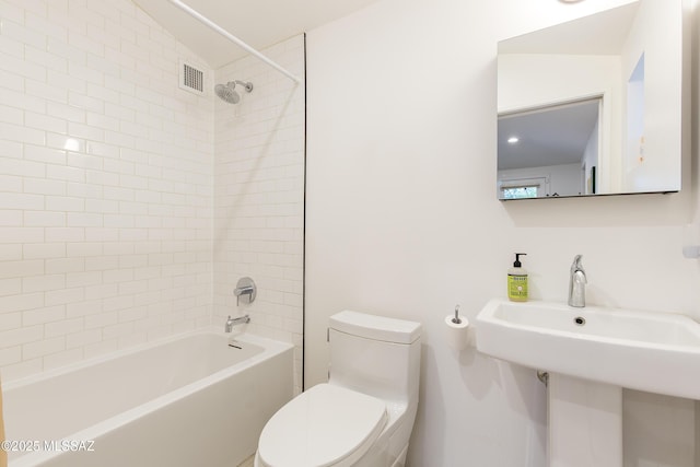 2626 E 4th St, Tucson, AZ 85716 - bathroom featuring visible vents, a sink, shower / bathtub combination, and toilet