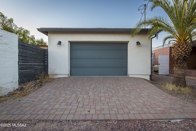 2626 E 4th St, Tucson, AZ 85716 - garage featuring decorative driveway and fence